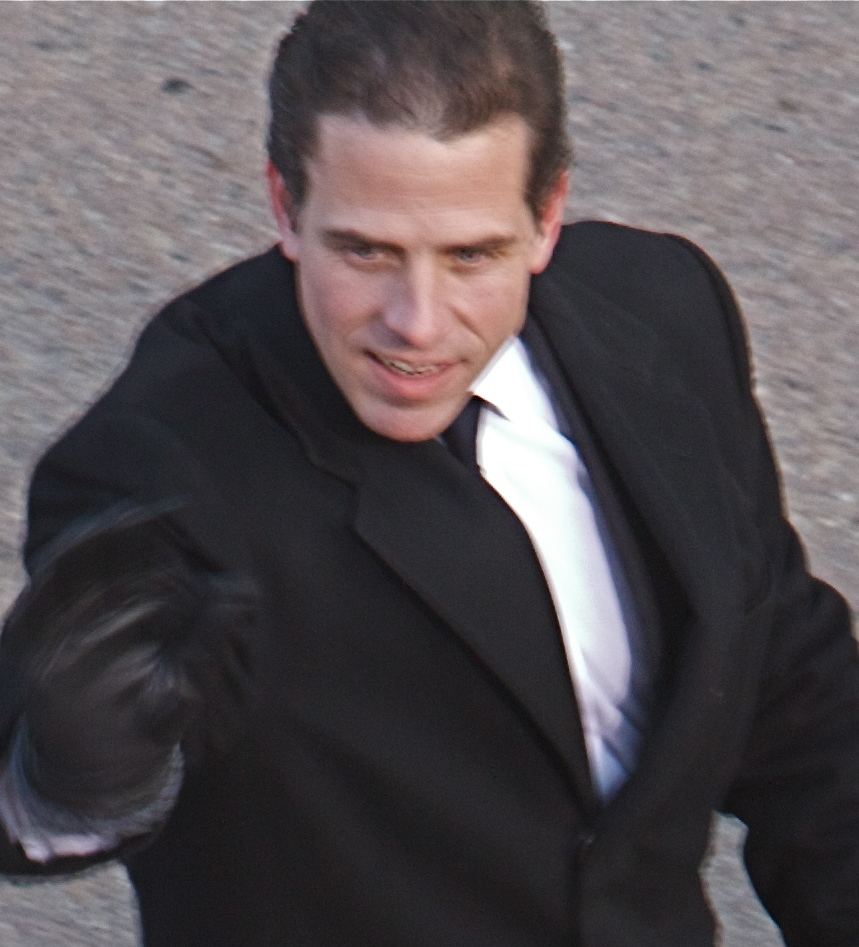 Man in a dark suit walking toward the camera